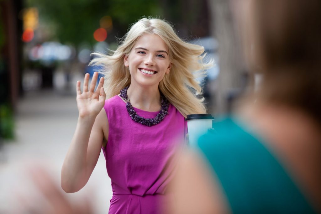 15075673 - happy shopping woman greeting friend on street