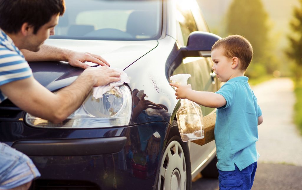 28858206 - young father with his little son washing car