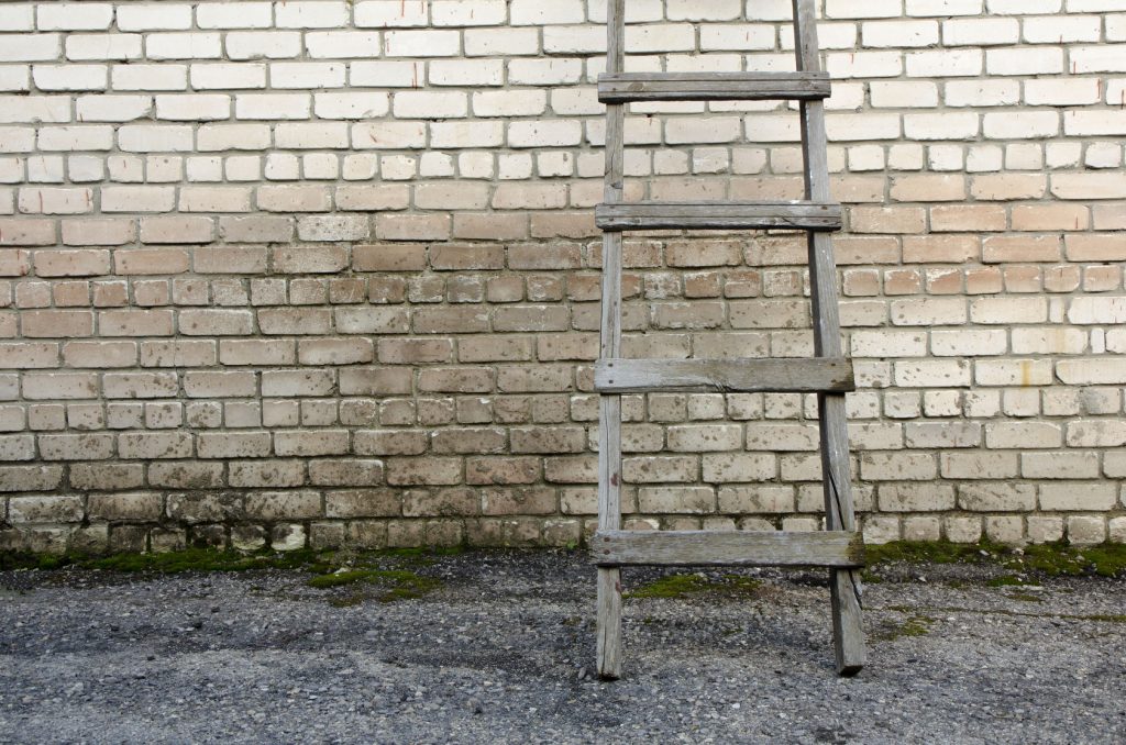 60273715 - old wooden ladder against a wall