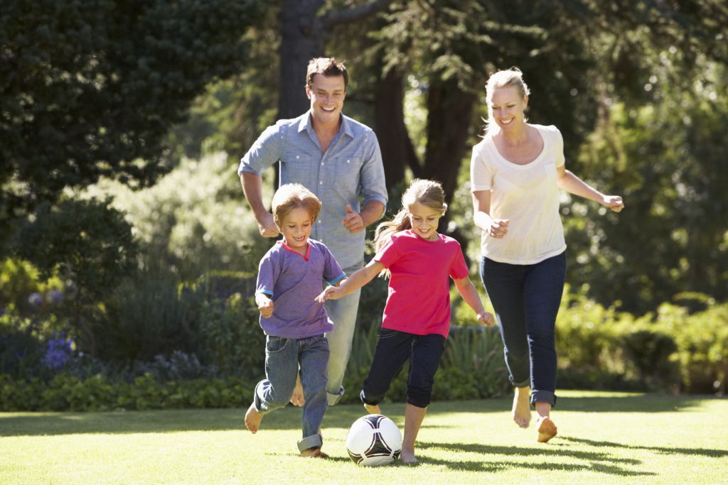 42247826 - family playing football in garden together