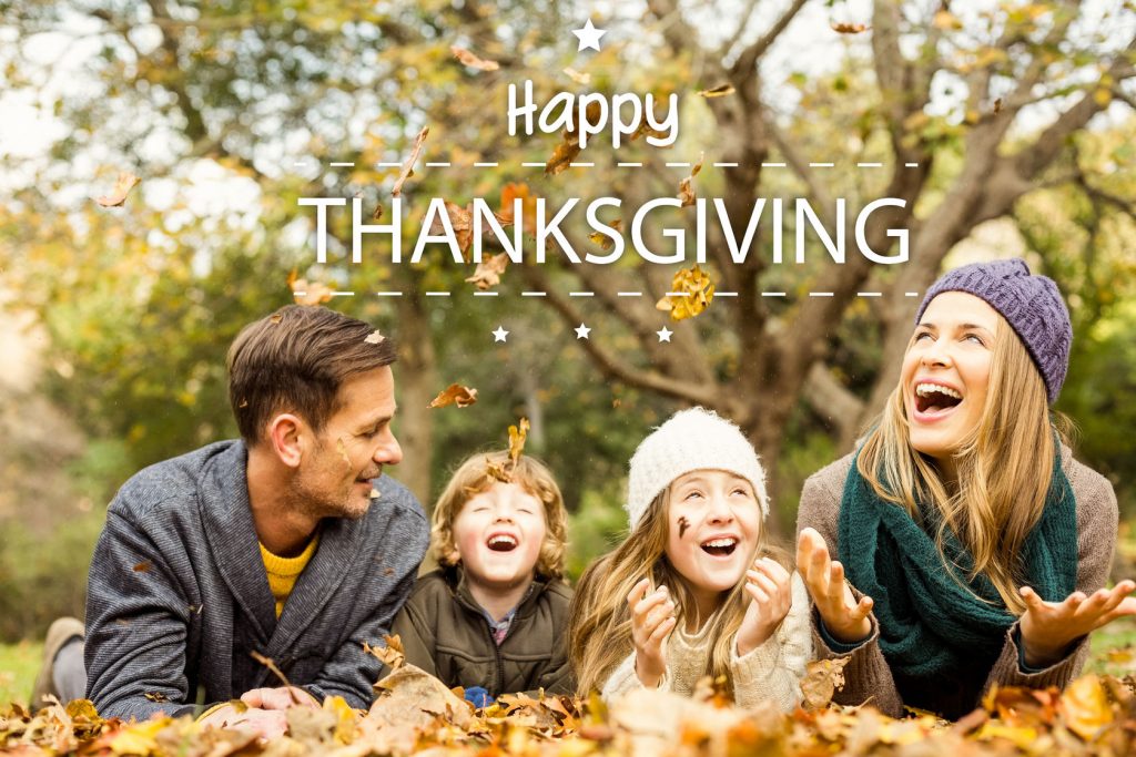 47543296 - happy thanksgiving against smiling young family throwing leaves around