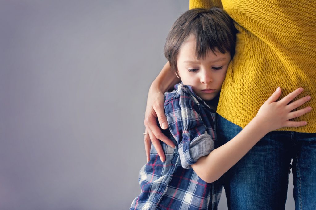54222012 - sad little child, boy, hugging his mother at home, isolated image, copy space. family concept